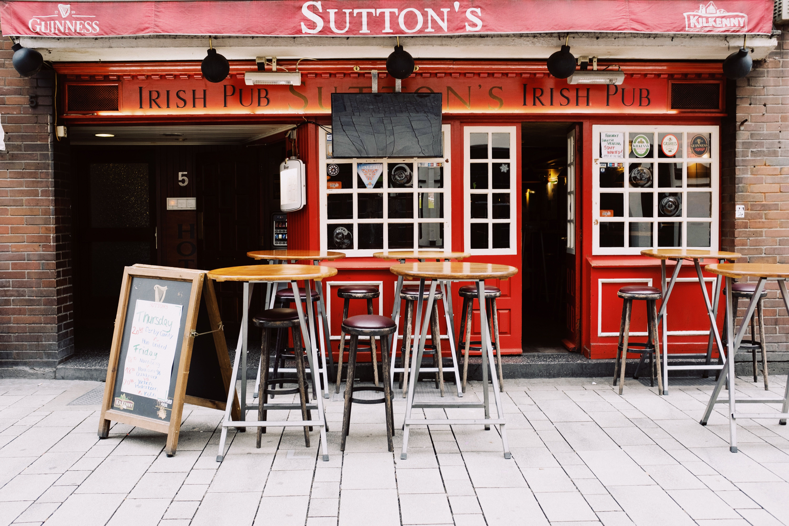 The empty terrace of a village pub, tables and chairs unused